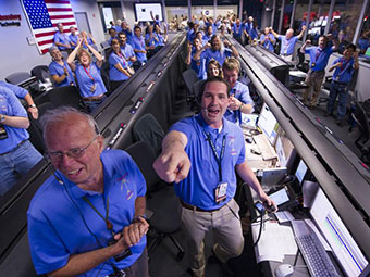 Celebrating Curiosity, NASA/JPL ground controllers react to learning the Curiosity rover had landed safely on Mars and begun to send back images to NASA's Jet Propulsion Laboratory on Sunday, Aug. 5, 2012. The rover will assess whether Mars ever had an environment able to support life forms. Credit: NASA/Bill Ingalls